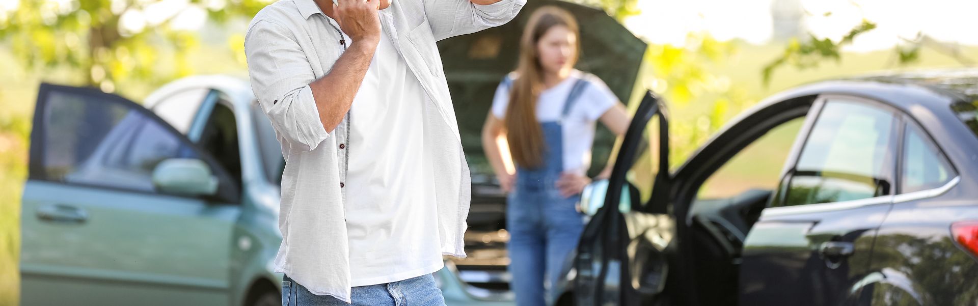 man calling the police after a car accident